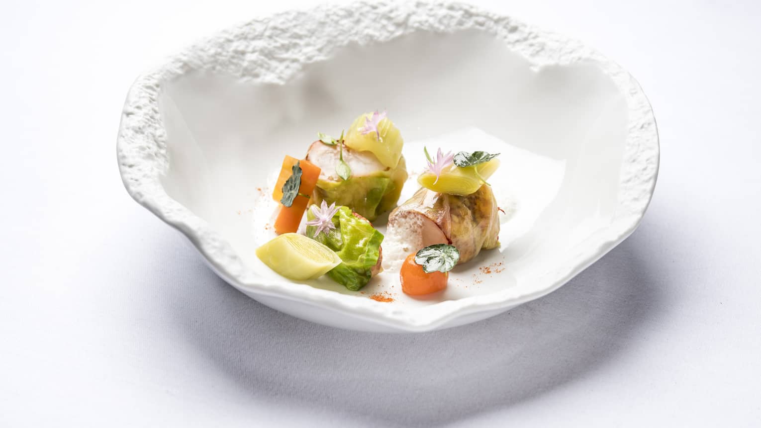 Blue Lobster Nage in artistic white bowl