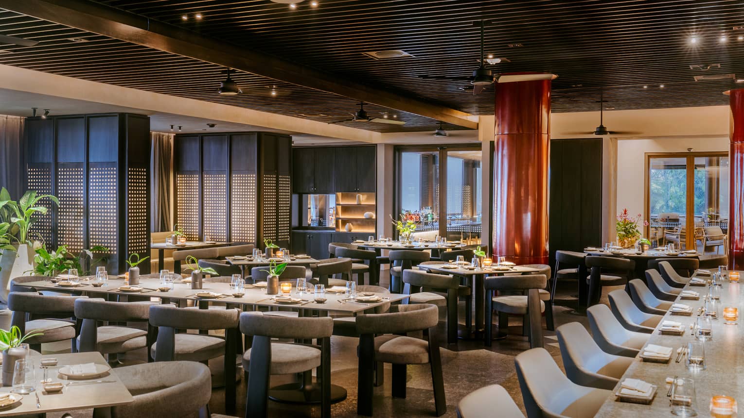 Indoor restaurant featuring long tables with grey chairs