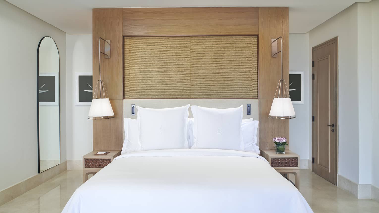 Bed set against a freestanding headboard wall