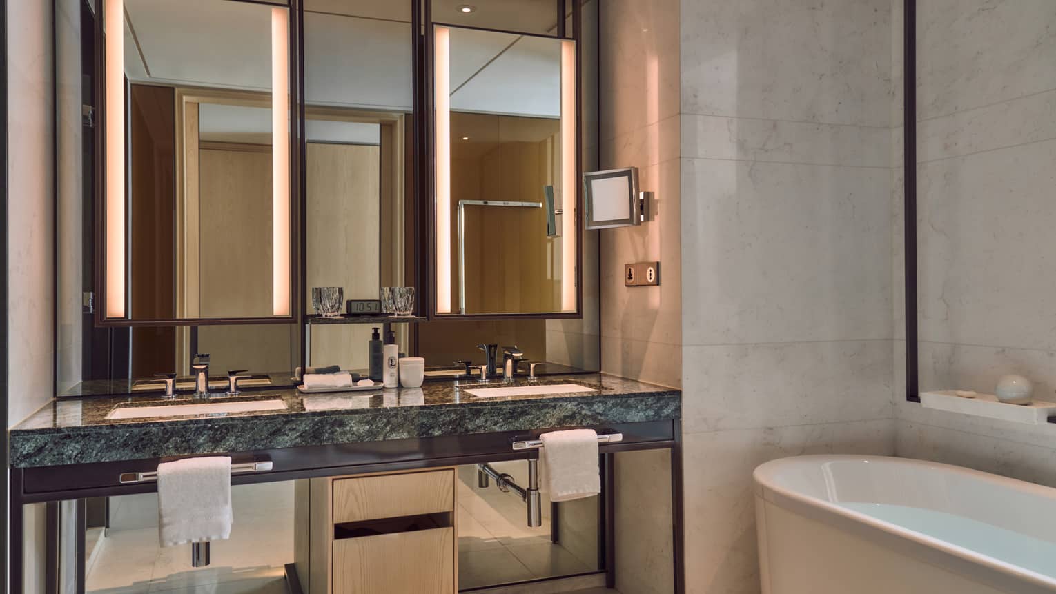 Modern hotel bathroom with deep soaking tub and double vanity