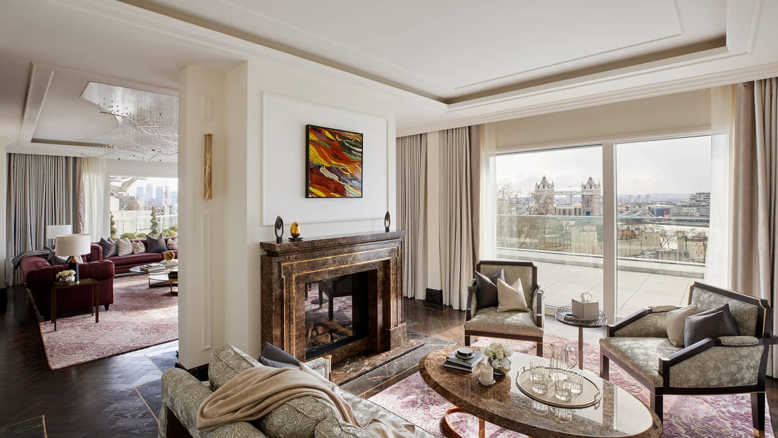 Elegant residence living room with fireplace and tall windows with river views