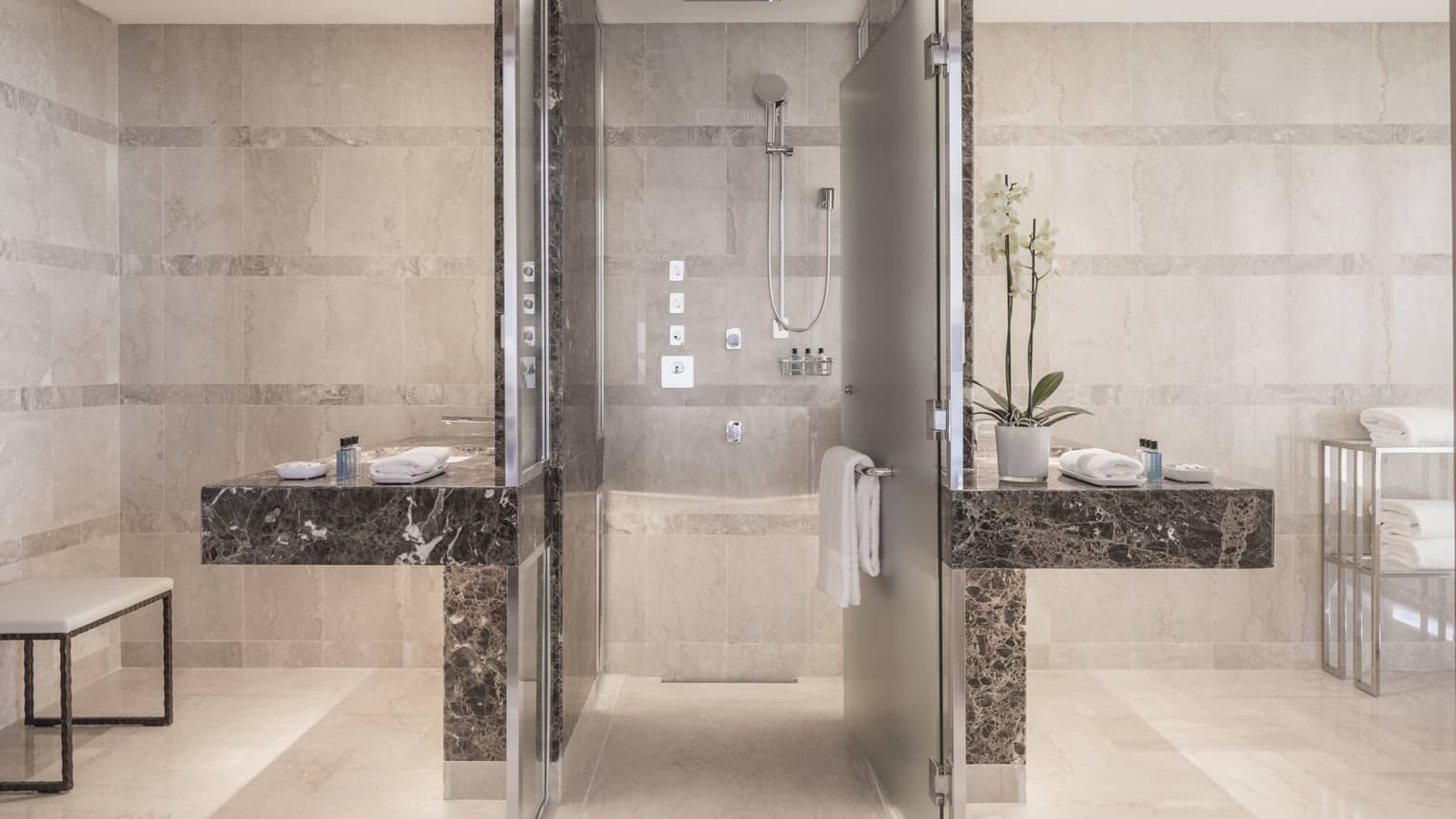 Presidential Suite bathroom, walk-in shower flanked by black marble vanities