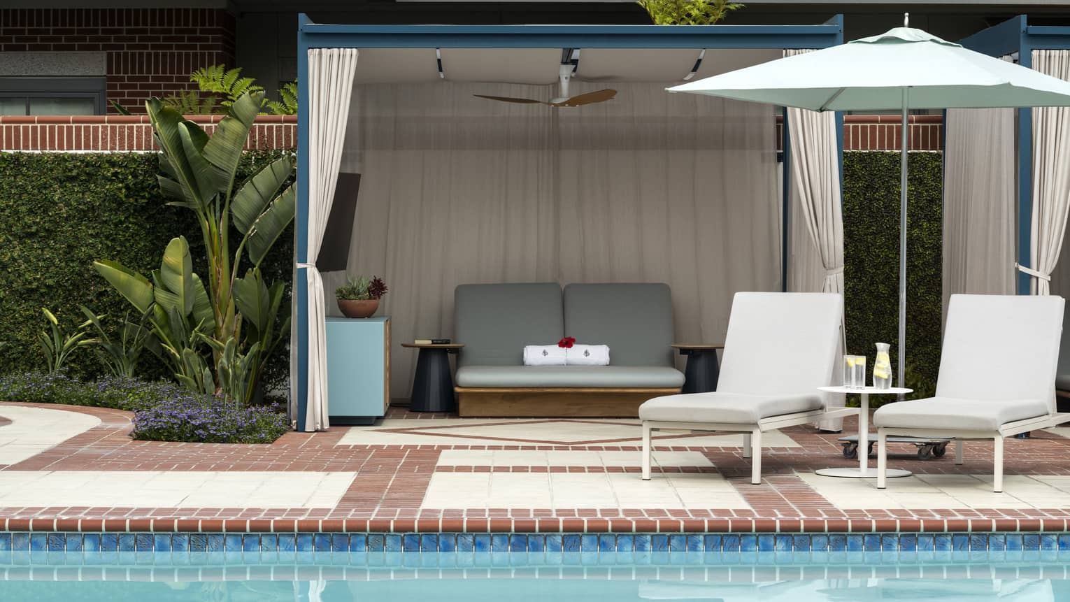 Pool with lounge chairs and umbrella, along with a canopy.