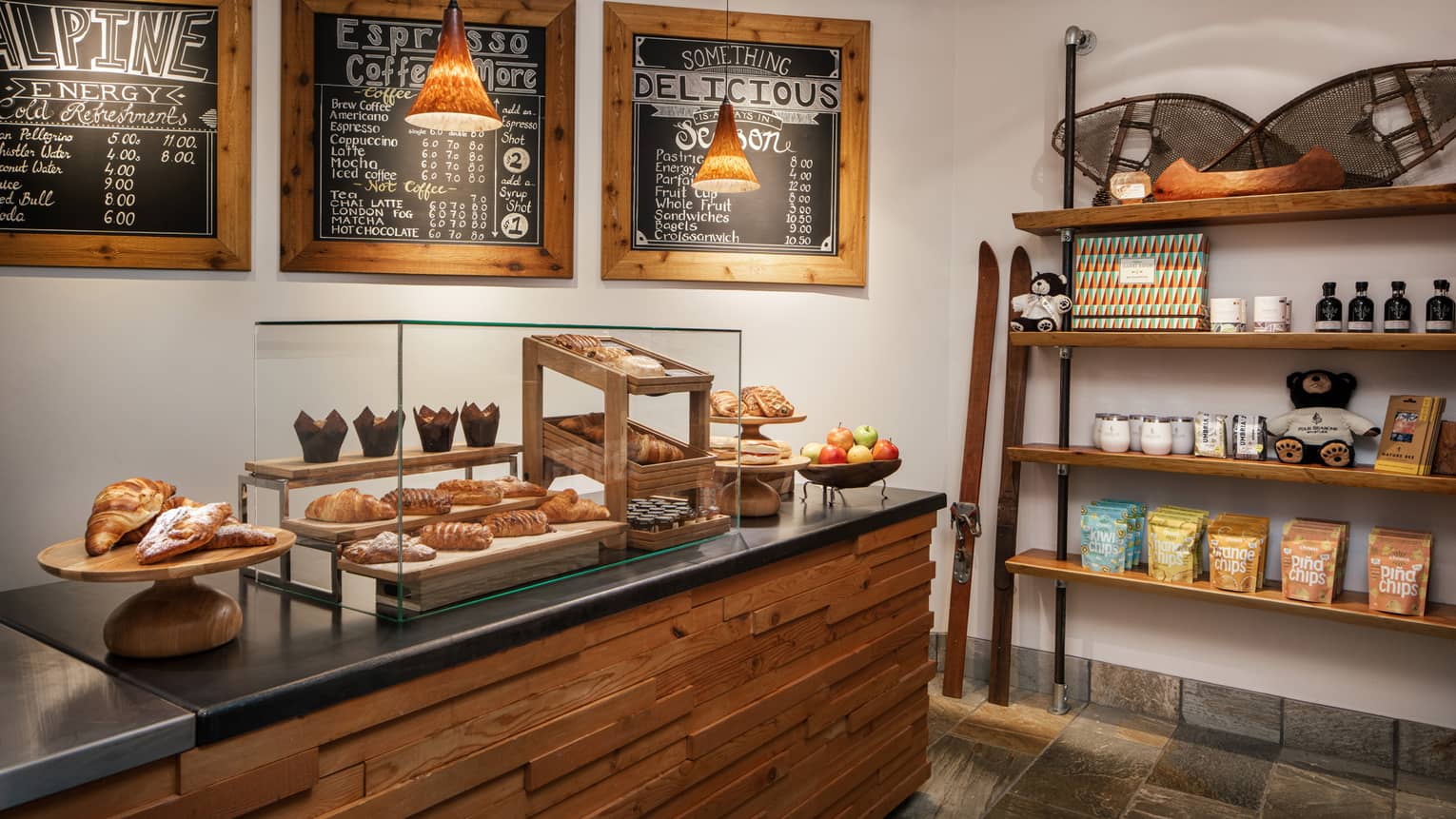 A cafe with pastries on display and coffee for sale.