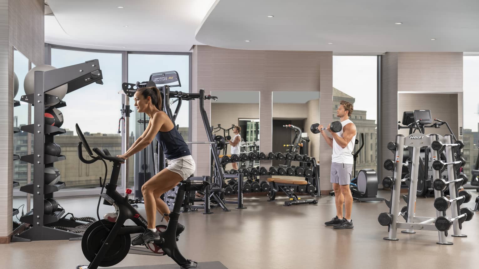 A man and woman using gym equipment.