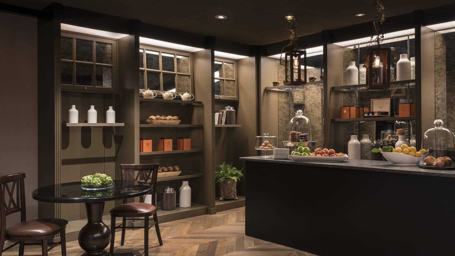 A coffee store that dimly lit with a counter and small table.