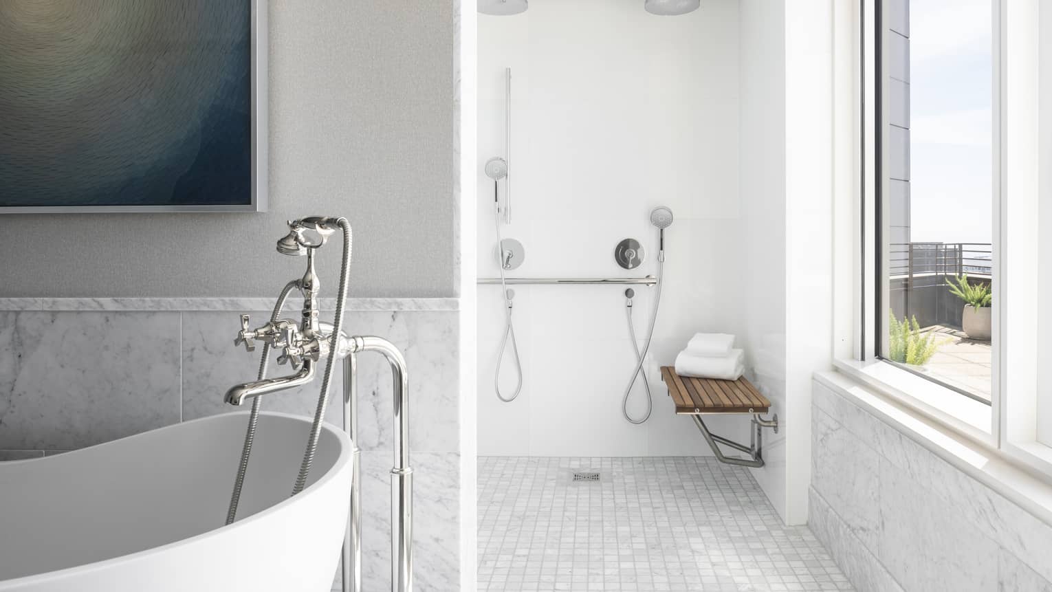 White and light grey marble bathroom with tub and wheelchair-accessible shower
