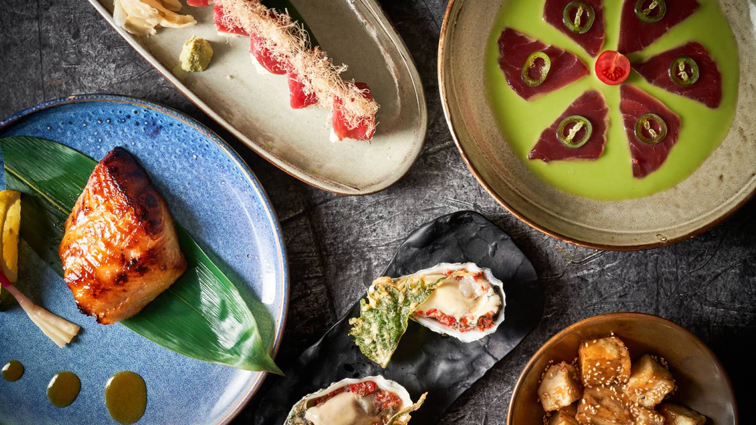 Closeup of five colourful Asian-inspired dishes