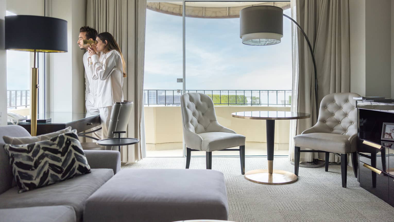 Two guests looking out of the window of their guest room