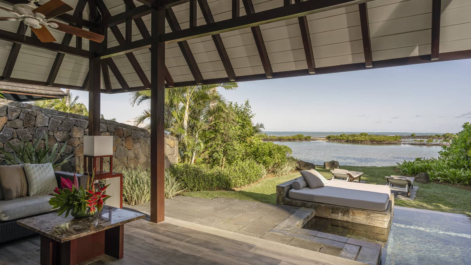 Wooden deck with small pool, day bed, sofa, vaulted pavilion covering