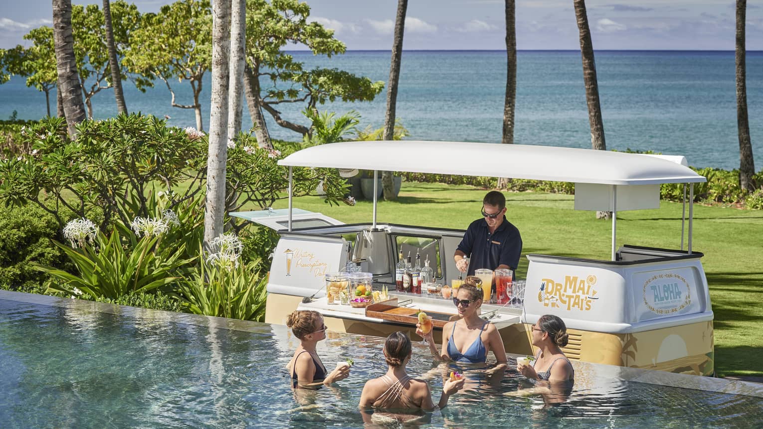 Male bartender in swim-up pool bar cart in tropical location