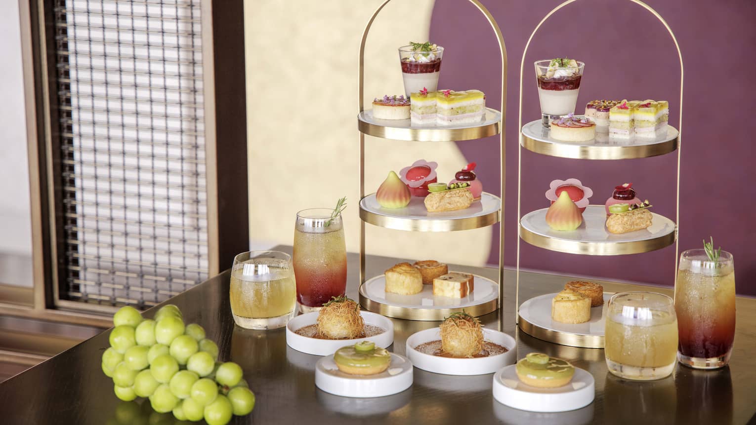 Afternoon tea spread on a table, featuring muscat grapes