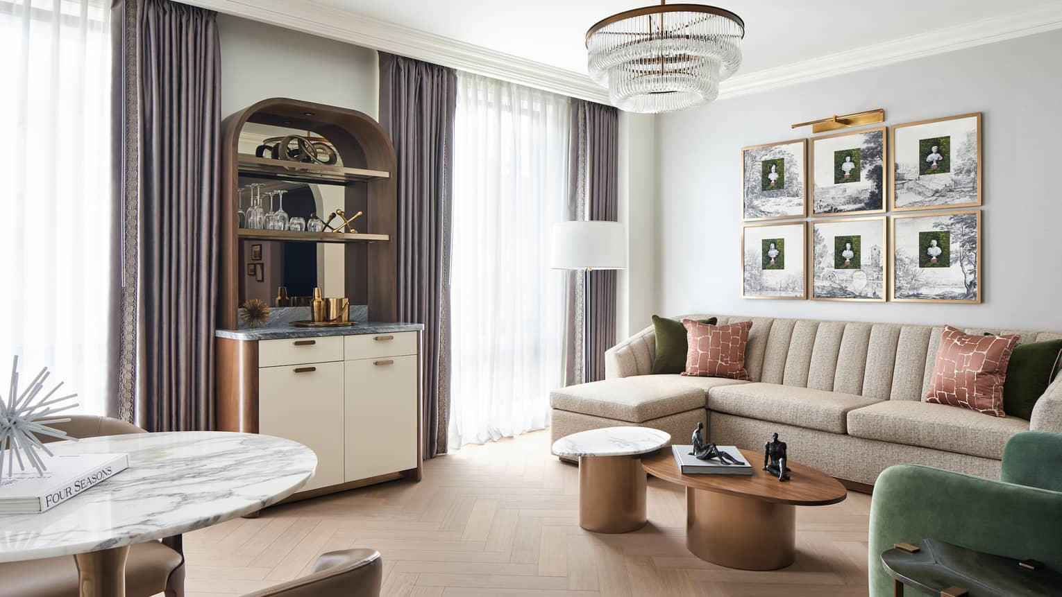 Luxury hotel suite living room with sofa, chair, bar and round marble dining table with two chairs, at Four Seasons Hotel Washington, DC