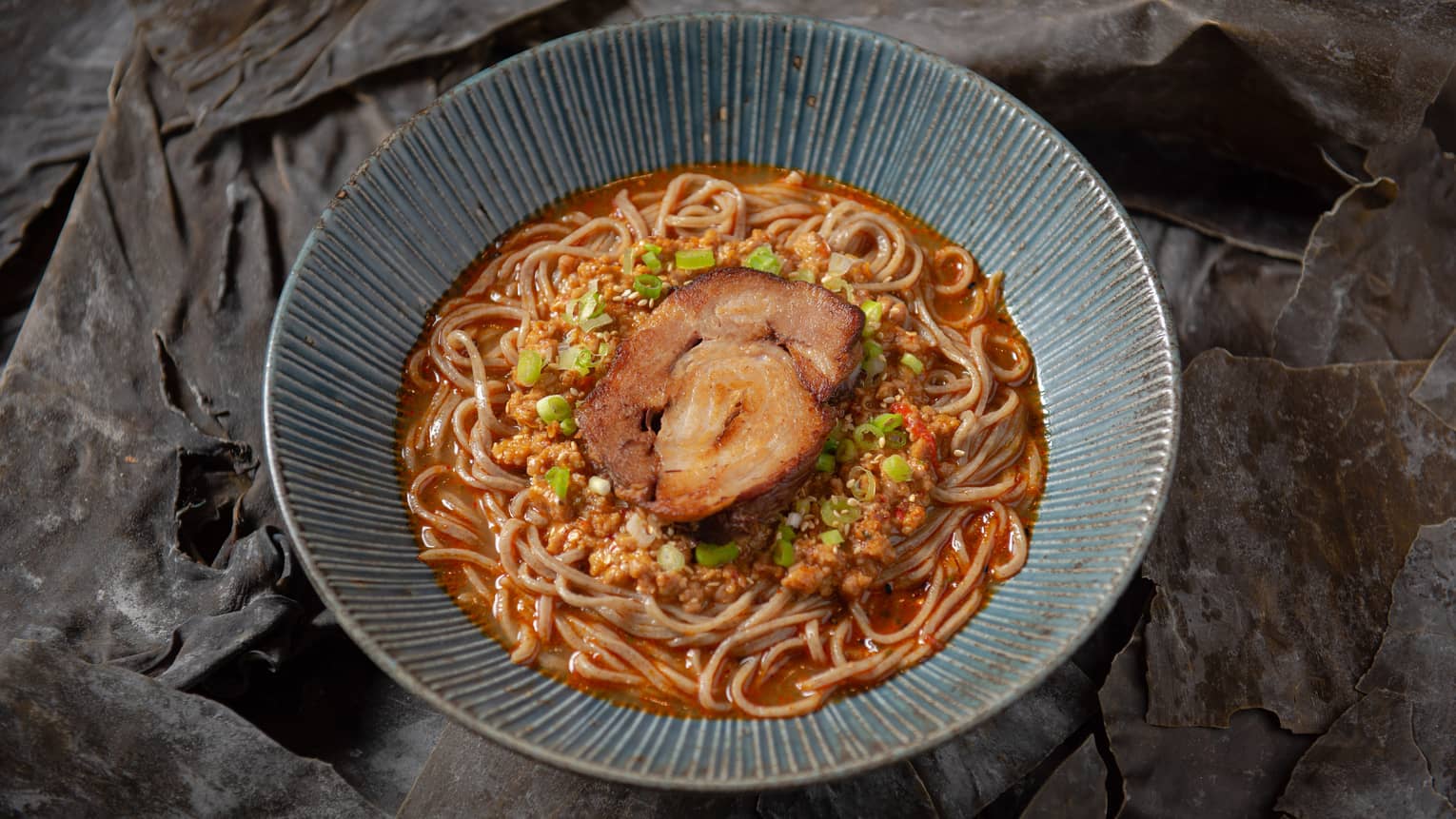 A bowl of Tantanmen ramen noodles with pork