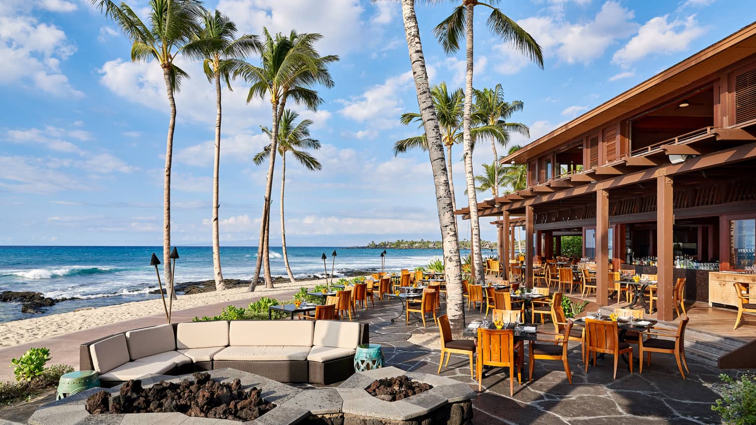 ULU Ocean Grill sunny patio dining room under palm trees, near beach 