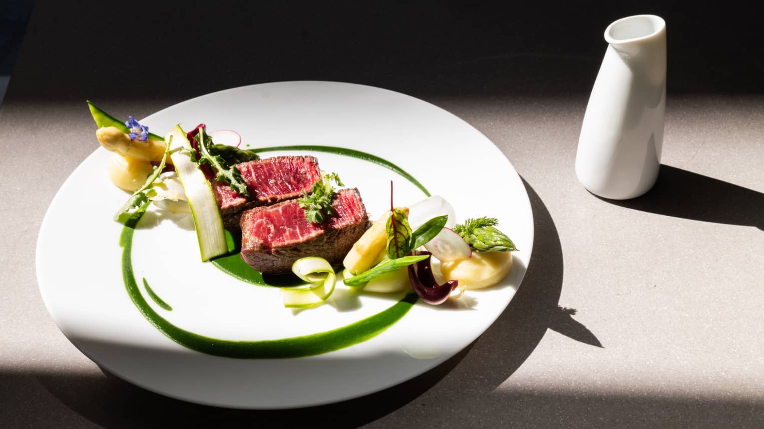 Chargrilled Damini Beef Fillet with Asparagus and Mashed Potatoes on round white plate