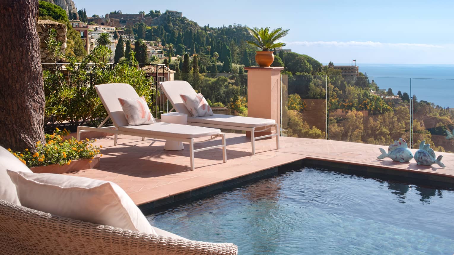 Private, sea-view terrace with two lounge chairs and plunge pool
