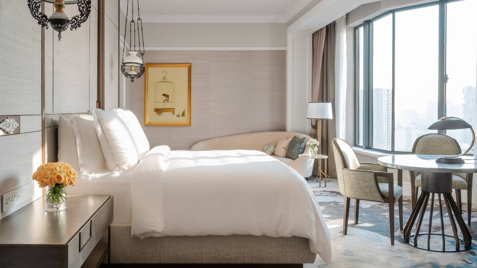 Ambassador Suite Bedroom with dining area and floor-to-ceiling views of the city