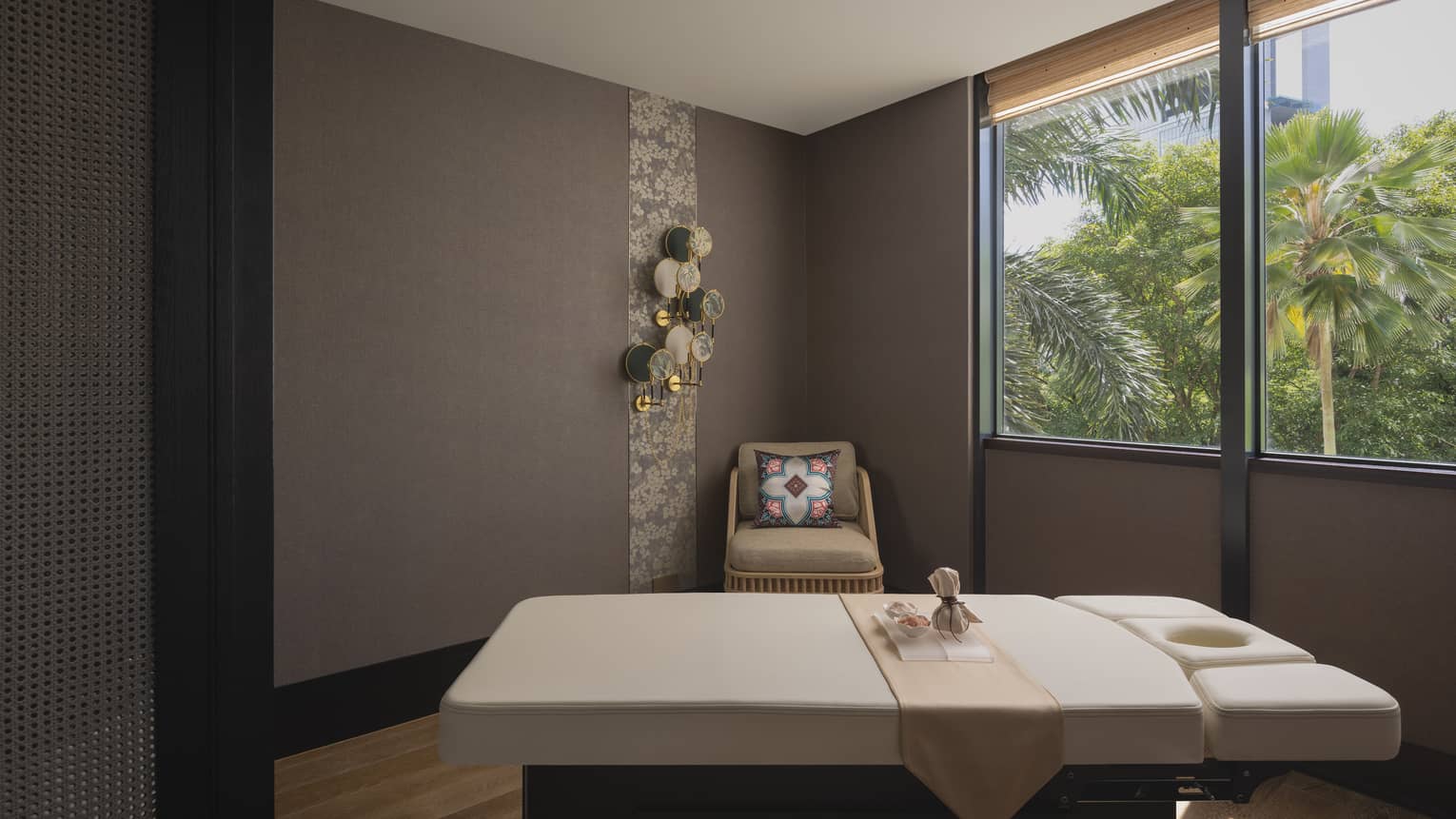 Massage table with a view of the jungle outside the window