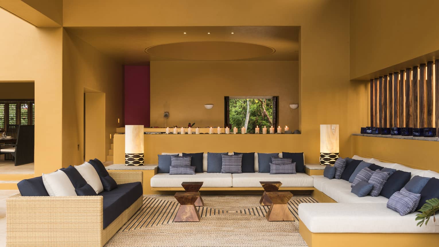 Large living room with three sofas and caramel-coloured walls