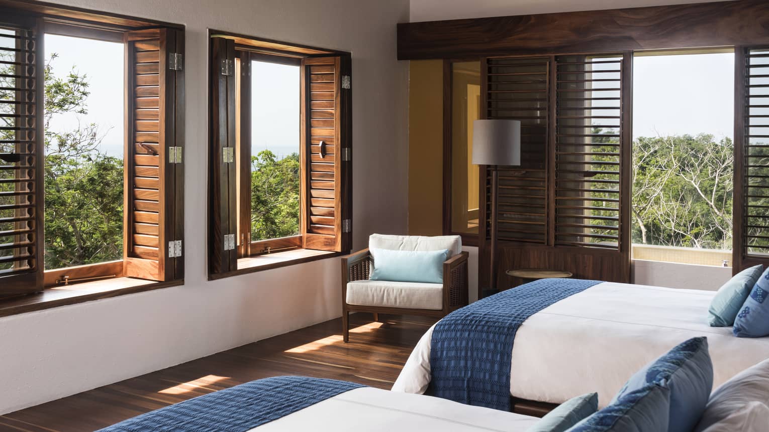 Bedroom with two queen beds, shuttered windows