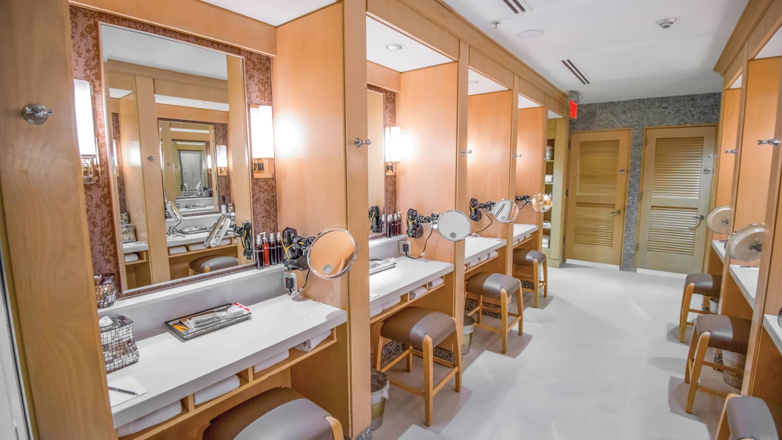 Fitness Centre dressing tables in rows along walls, each with mirrors, shaving mirrors, white towels, stools