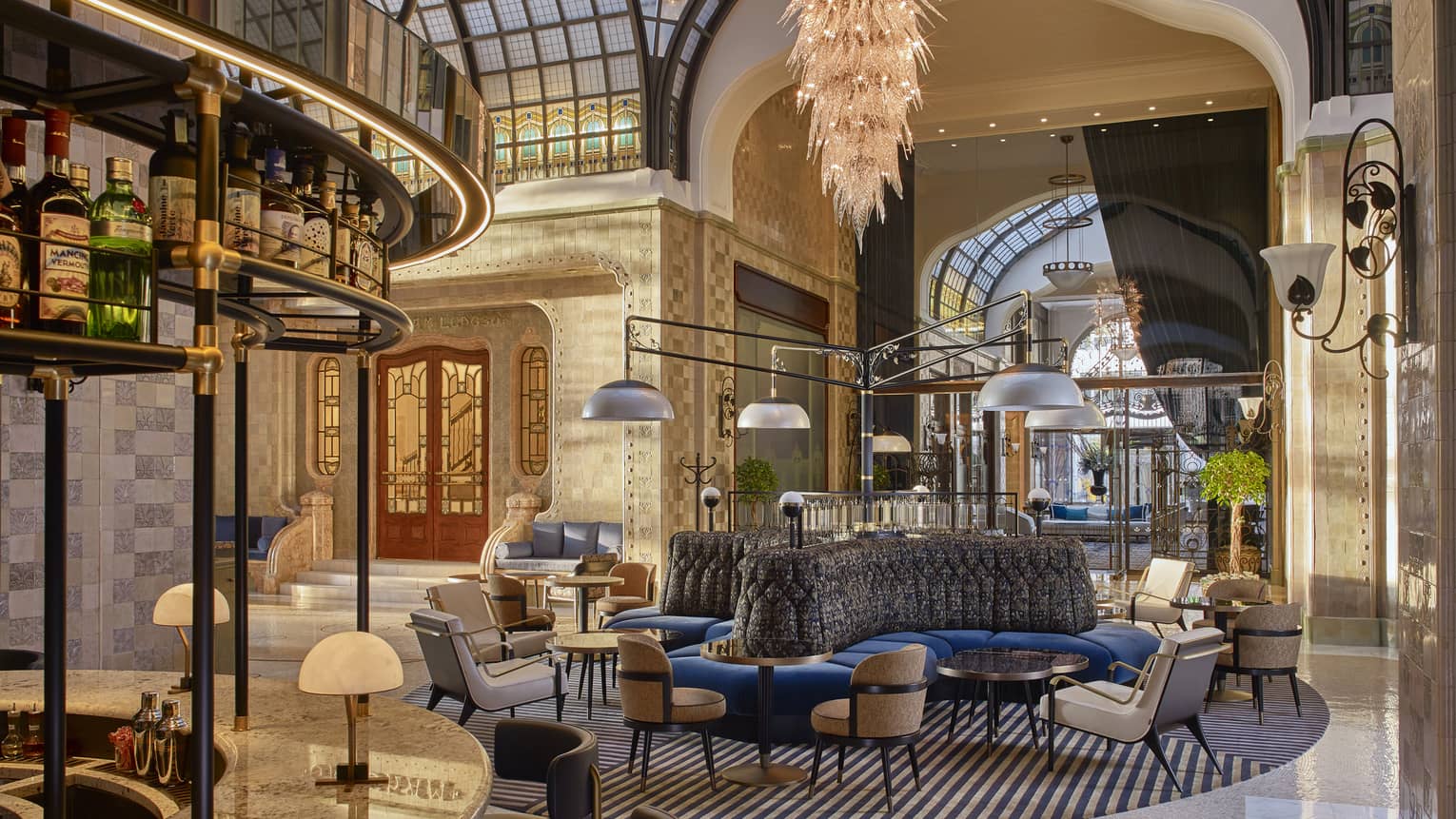 Modern lobby bar and lounge with brown leather or white chair pairs, blue banquettes