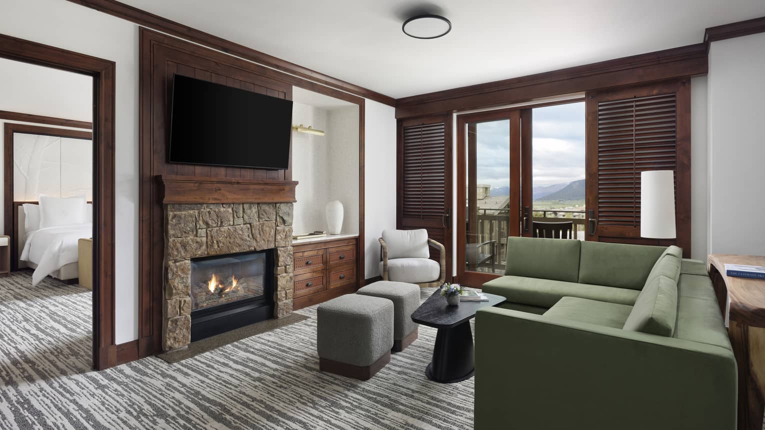 Living room with green sectional sofa, fireplace and TV
