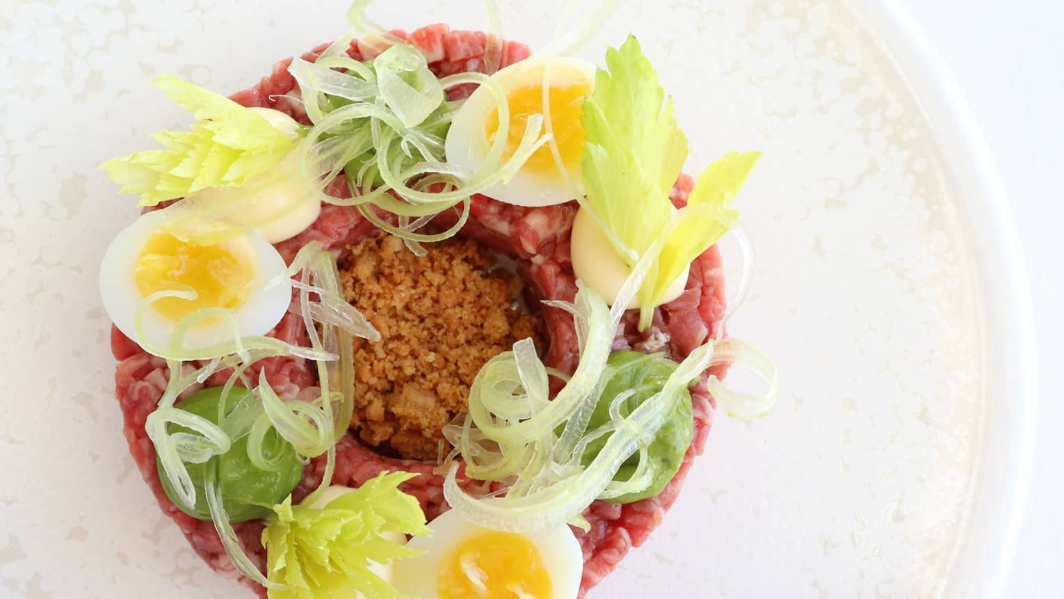 Fassona Tartare with Fassona Beef Tenderloin, Landaa Quail Egg, Royale, Salsa Verde and Anchovy Crumble