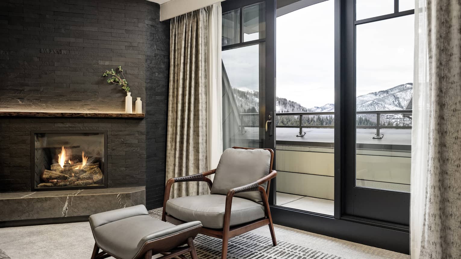 Arm chair in a hotel suite, next to the window looking out to mountains