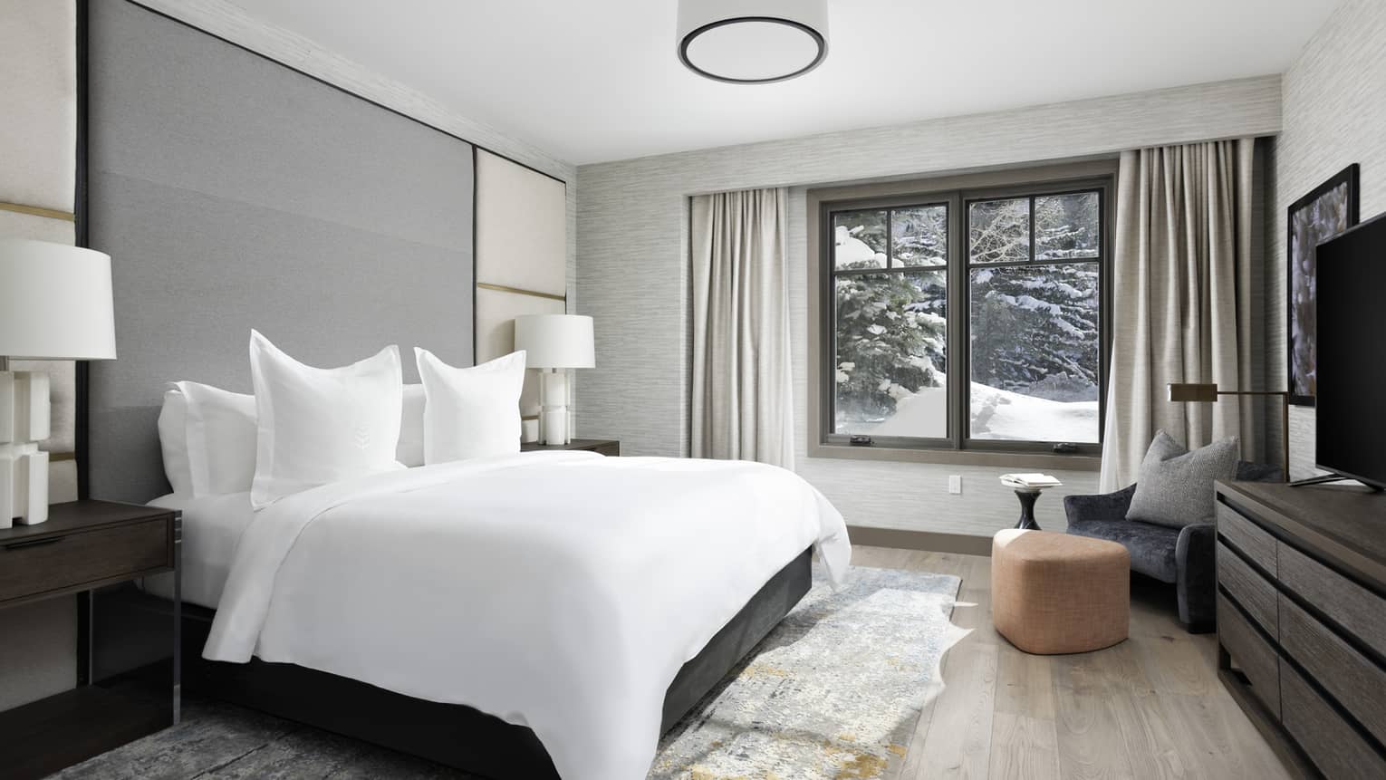Bedroom with white king bed, grey headboard wall