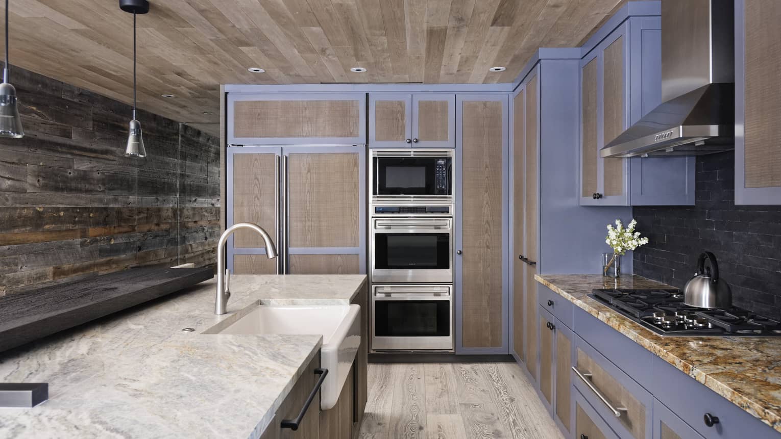 Mountain chic kitchen with wooden ceiling, walls and floors, marble counters