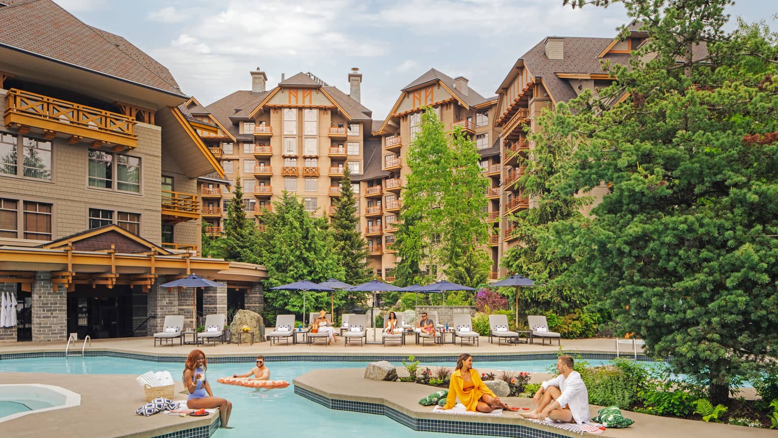 People lounging around an outdoor pool with large hotel buildings in the background.