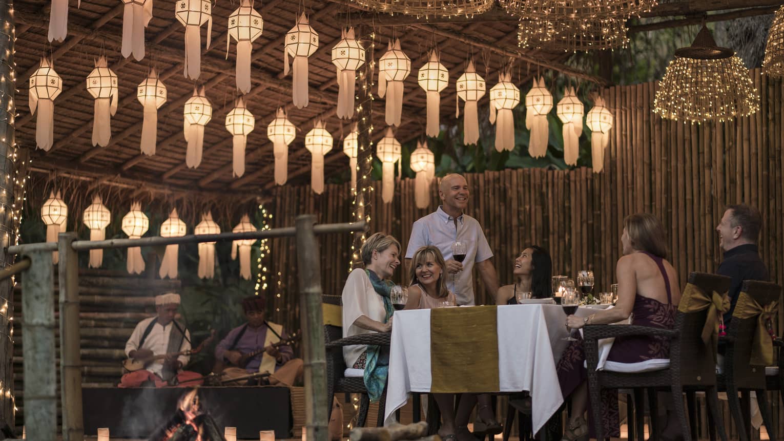Elephant Camp Dinner, smiling group of diners unders rows of paper lanterns