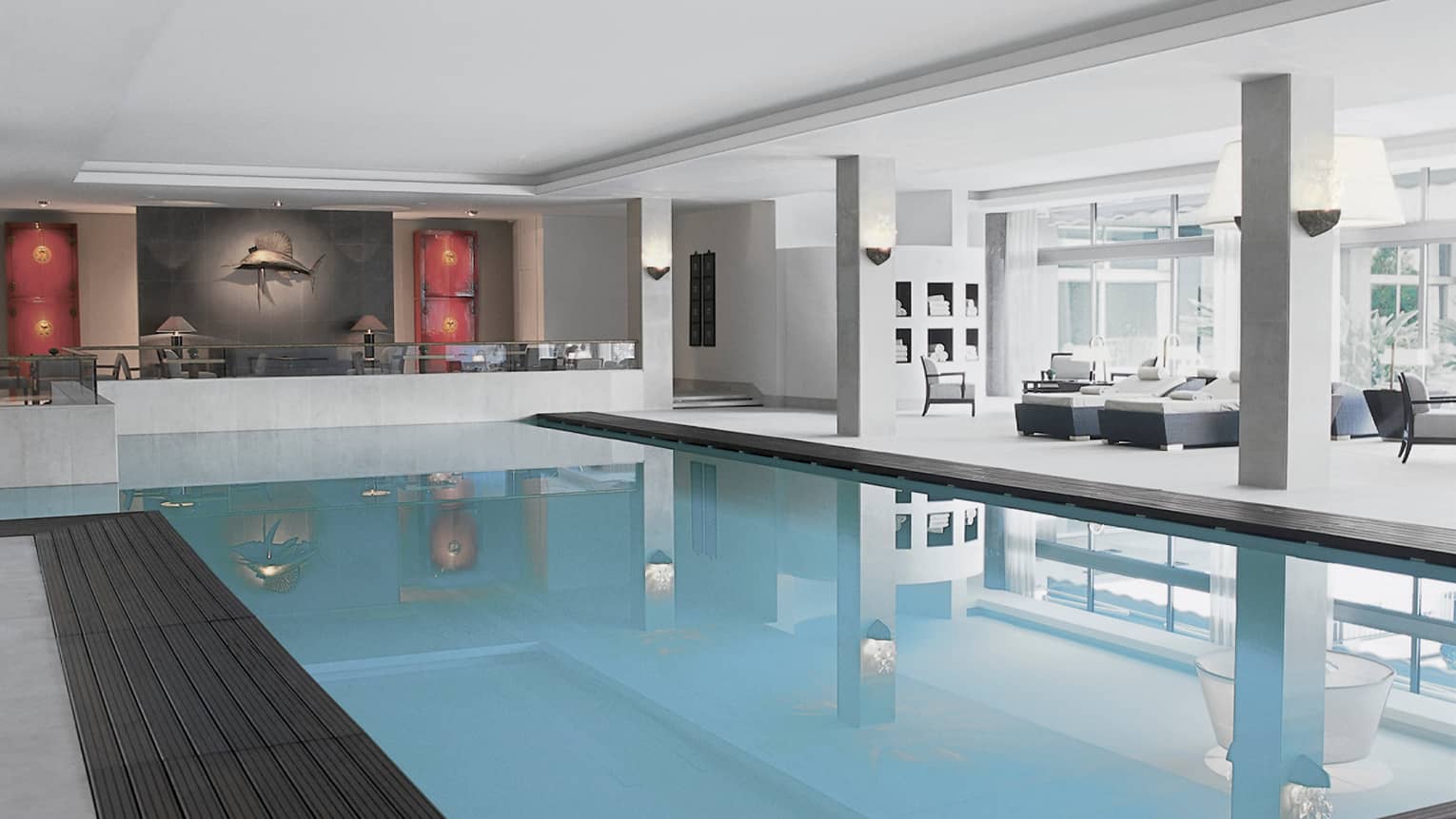 Elegant indoor pool area with lounge seating, modern décor and a large fish sculpture on the wall.