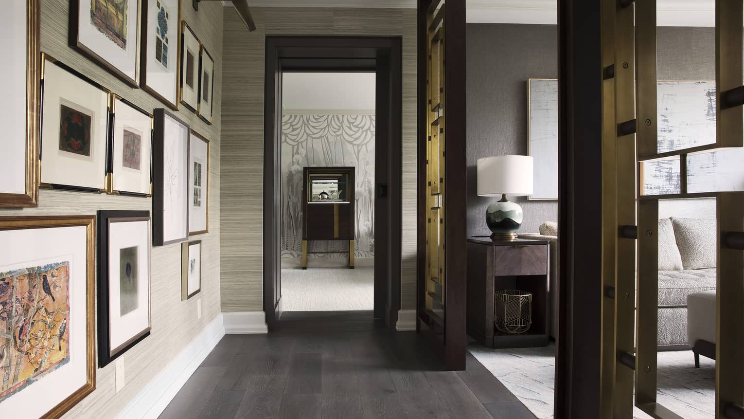 An assortment of frames decorates the hallway between the bedroom and living room