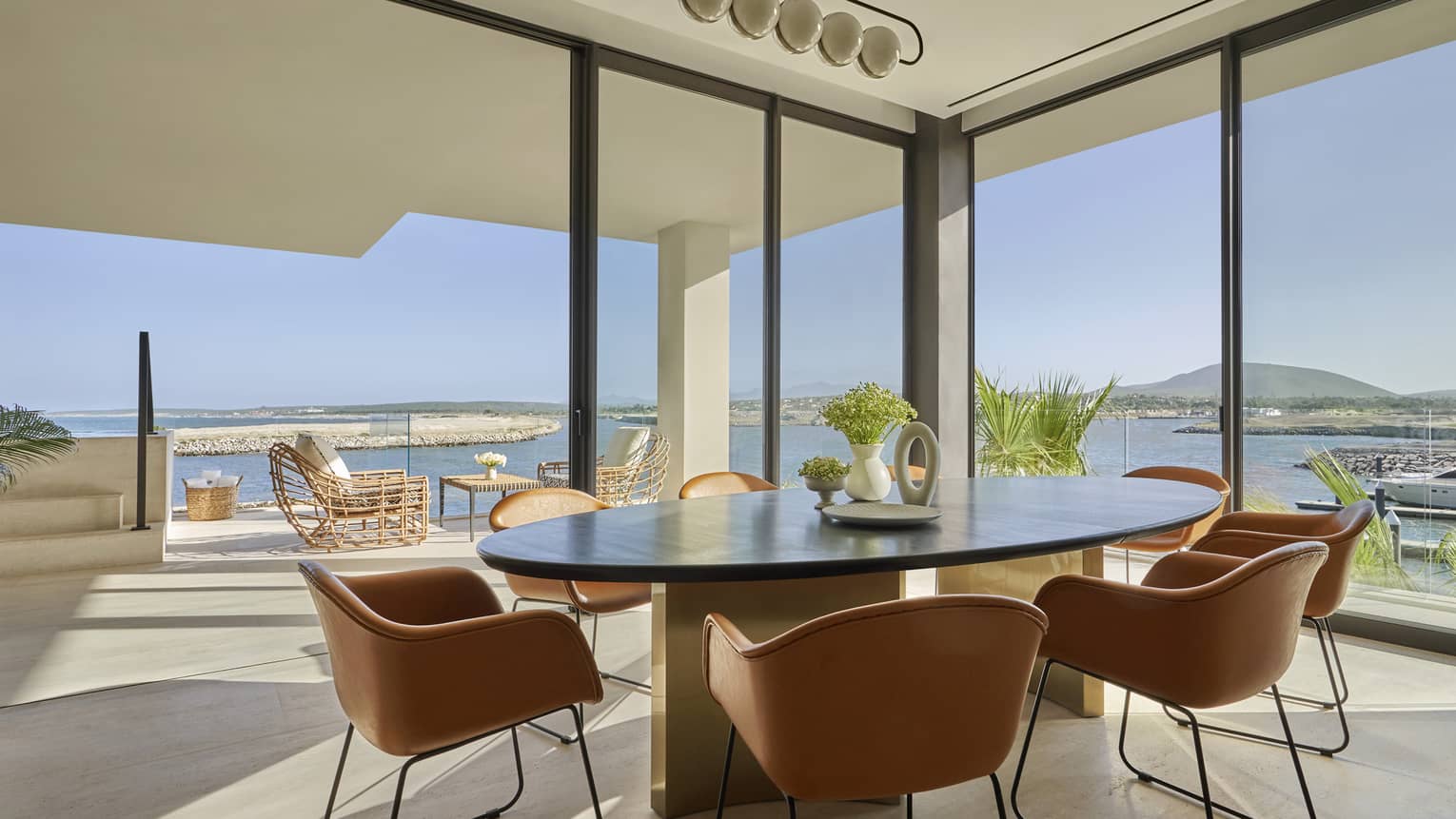 Ocean-View residence dining room with floor-to-ceiling windows and ocean view