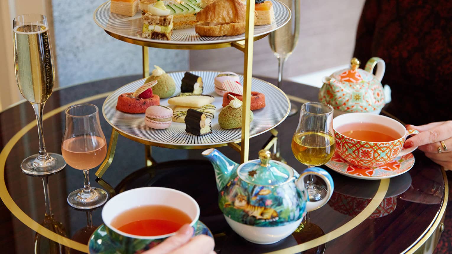 A tea set with pastries and small foods.
