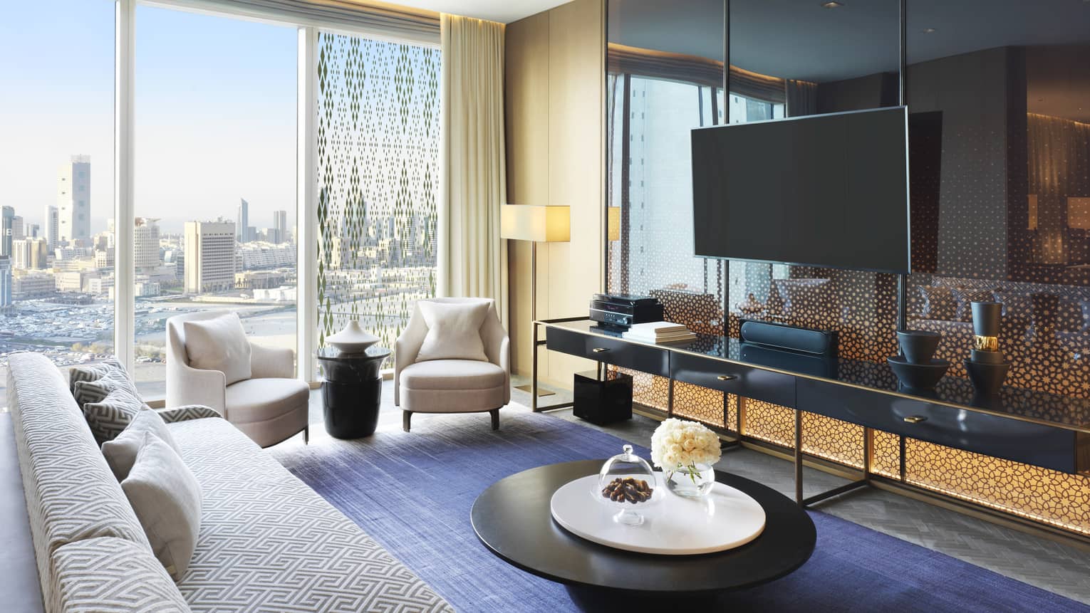 State Suite long white sofa, two modern armchairs by sunny window, large TV above long table