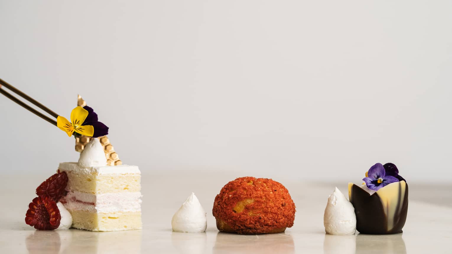 Three small, contemporary desserts set in a row