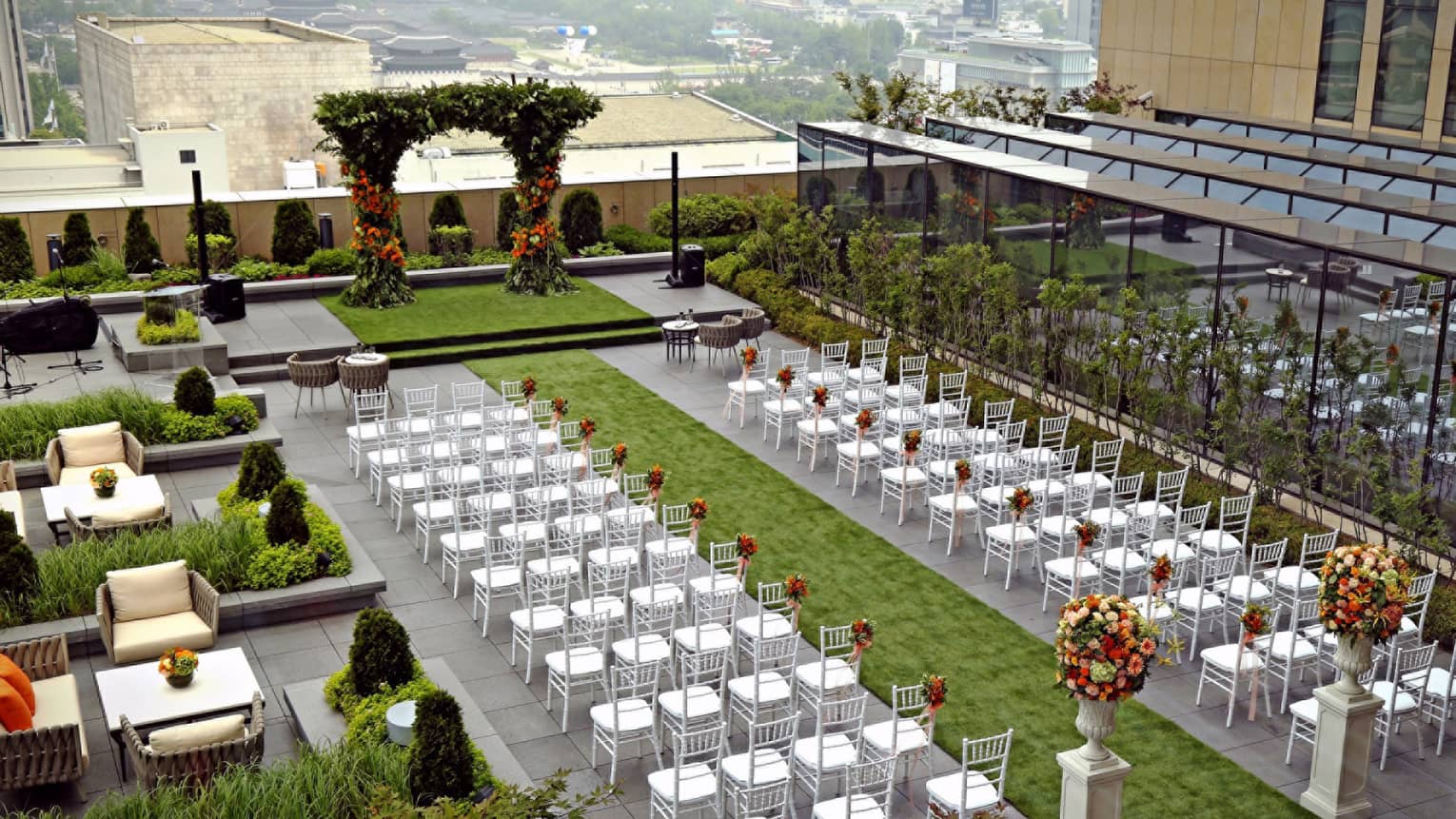 Aerial view of open-air Garden Terrace set up with white chairs and flowers for ceremony