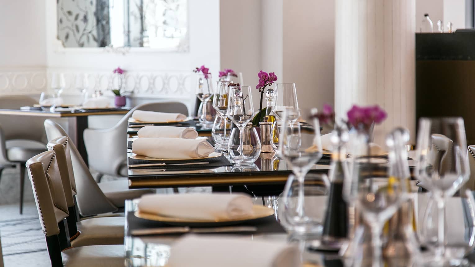 A row of dining tables set for a meal