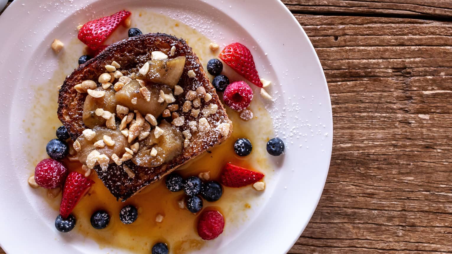Coconut brown sugar french toast with strawberries and blueberries