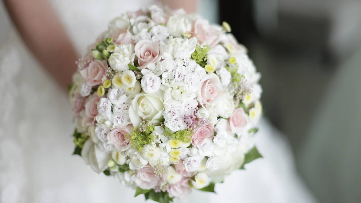 Round floral wedding bouquet with small white and pink roses 