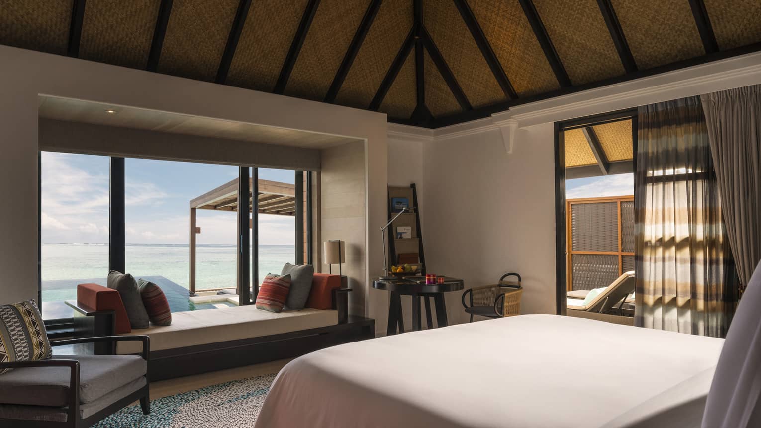 Looking out at the sea view from inside the sunrise water villa with pool