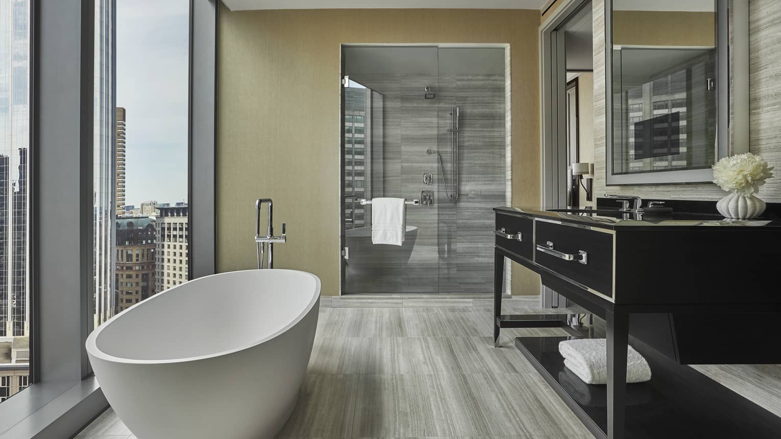 Free-standing tub sits next to floor to ceiling windows in the suite bathroom at four seasons hotel boston one dalton