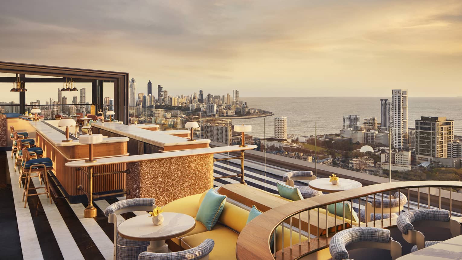 AER rooftop lounge at sunrise with views of Mumbai's skyline
