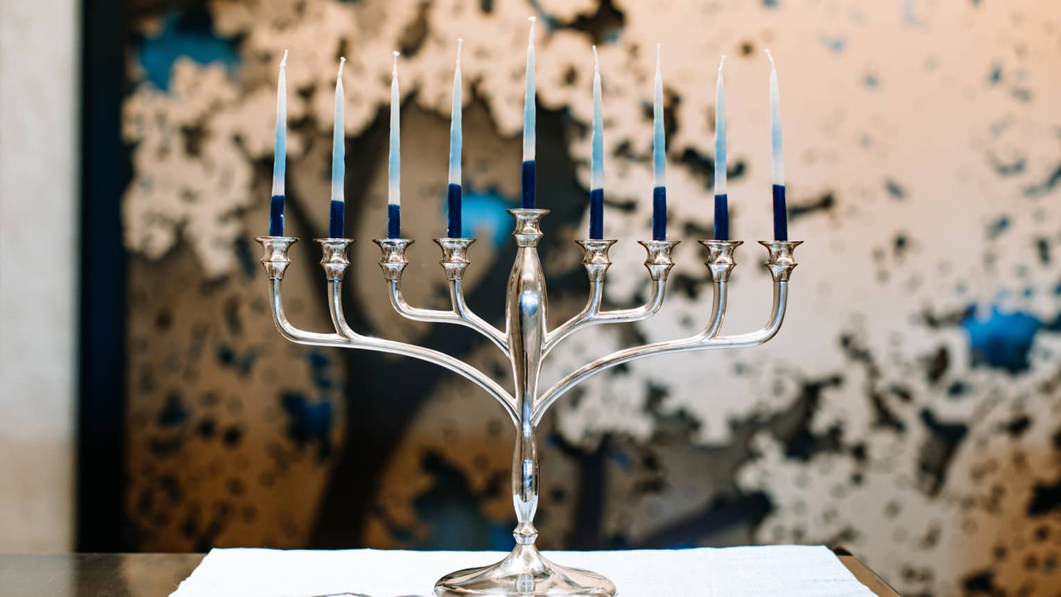 A silver menorah with 9 candles.