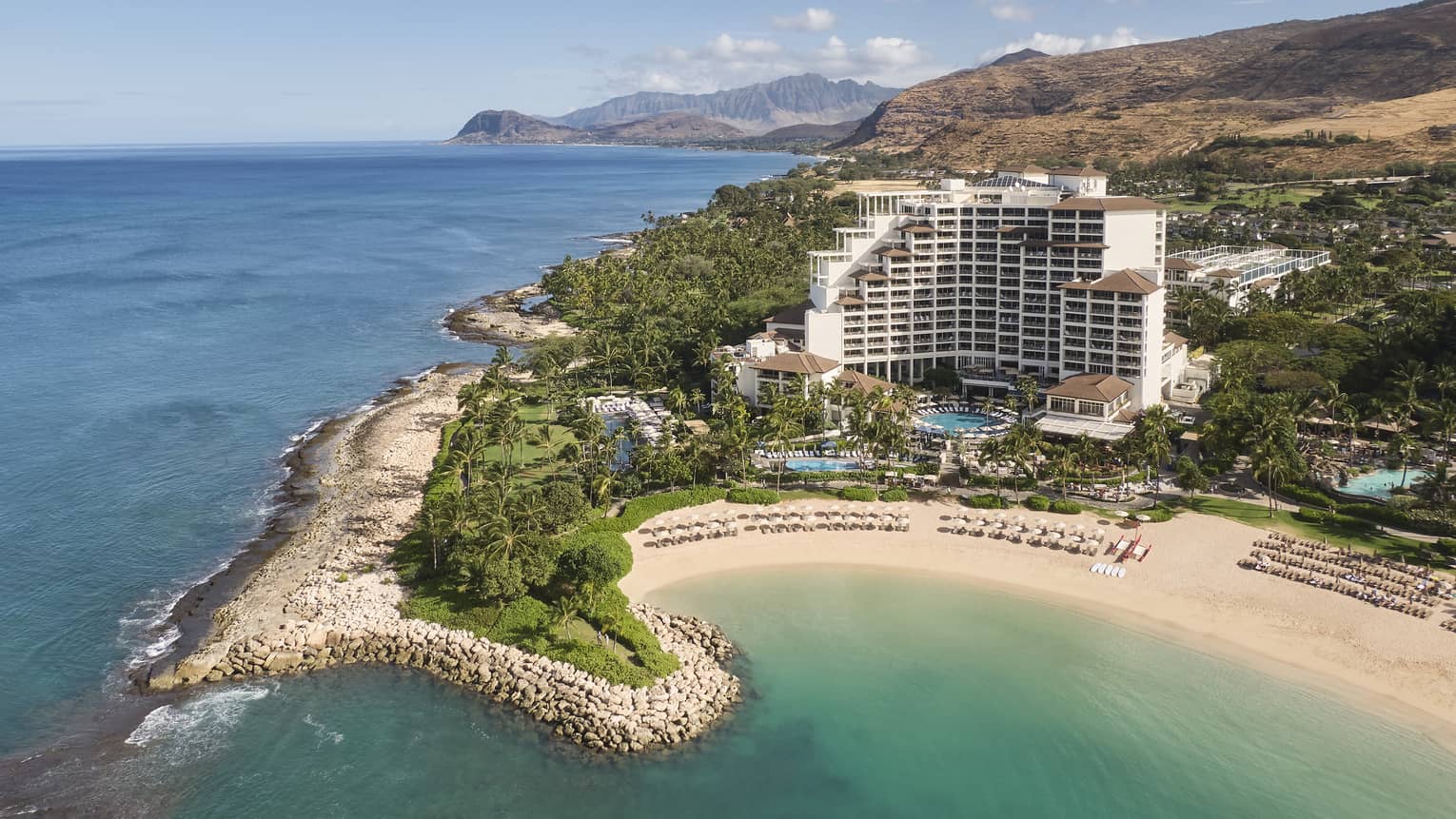 Exterior view of Four Seasons Resort Oahu on waterfront peninsula