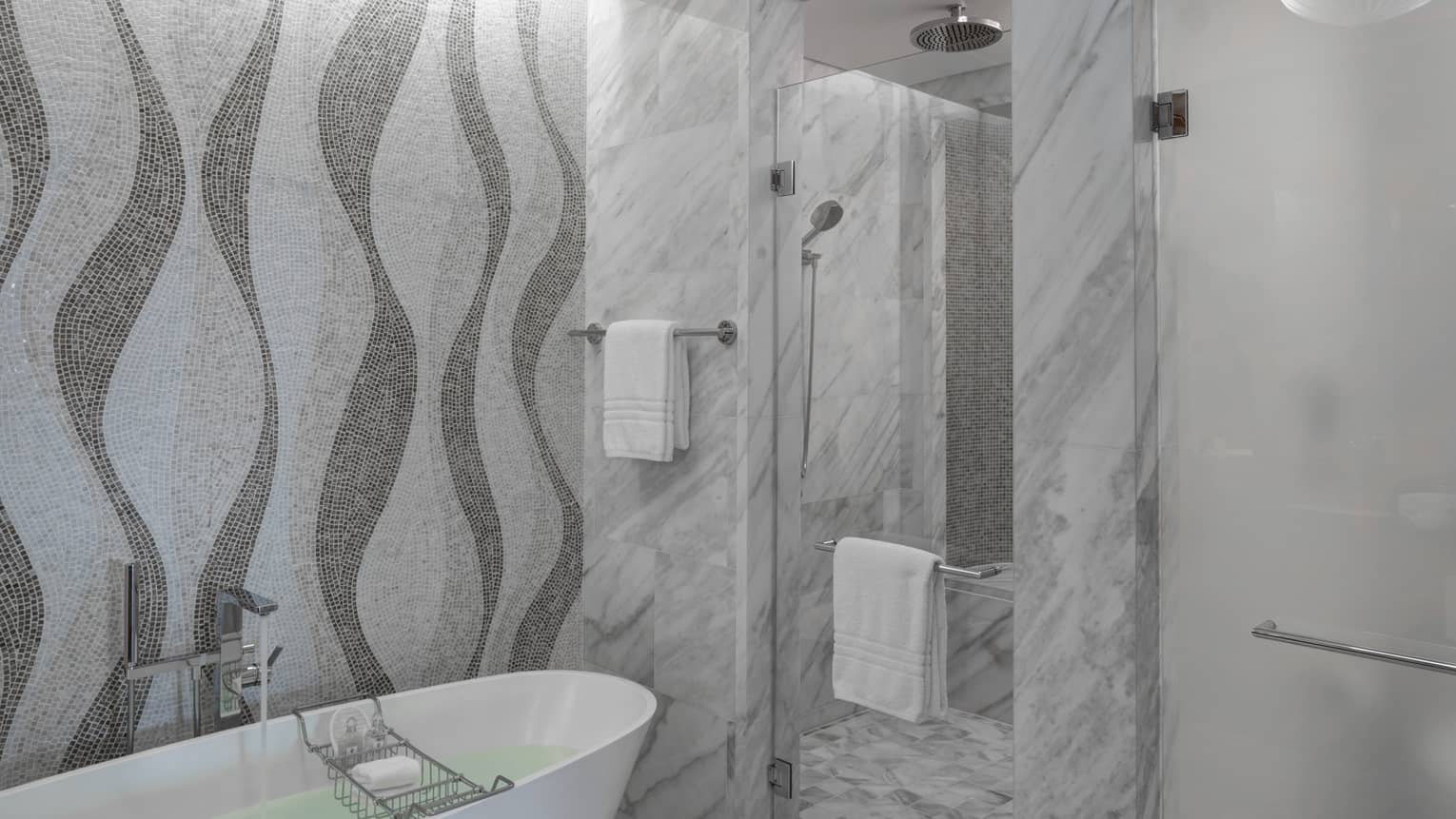 Bathroom with marble shower, mosaic tiled wall, freestanding tub